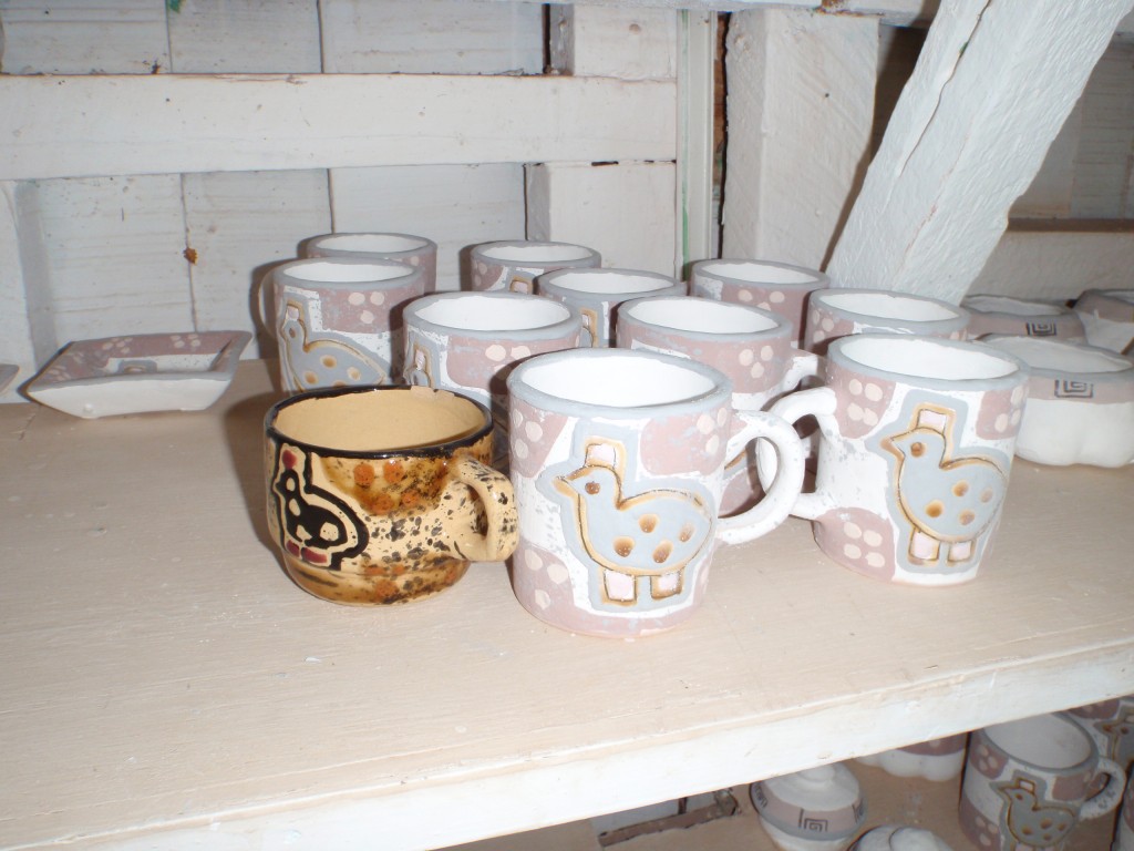 The dull pastel ones are the way the glazed cups look before they are fired. The bright colored one is the finished product after firing.